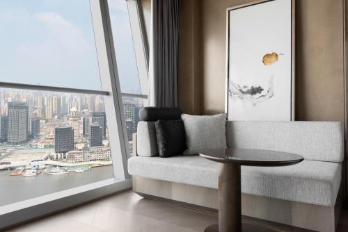 a living room with a couch and a large window at JW Marriott Marquis Hotel Shanghai Pudong in Shanghai
