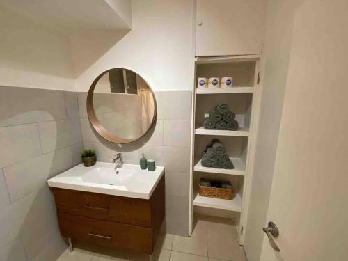 a bathroom with a sink and a mirror at 3 bd by airport El yunque Walk to the beach in San Juan