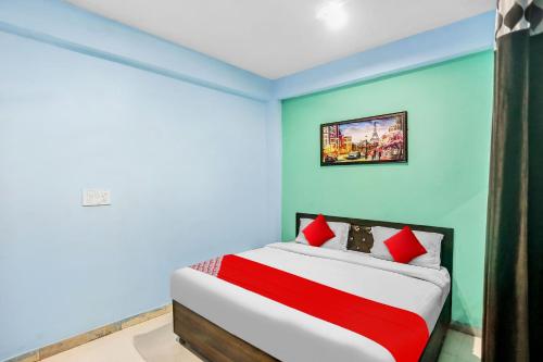 a bedroom with a bed with blue and green walls at Flagship Rk Residency Near Iskcon Temple Noida in Noida