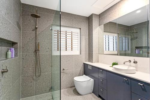 a bathroom with a shower and a toilet and a sink at Potts Point l 2 Bedroom Stylish Retreat in Sydney