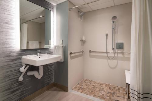 a bathroom with a sink and a shower at Torrance Marriott Redondo Beach in Torrance