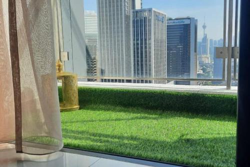 a window with a view of a city skyline at Sentral Suites Kuala lumpur By Leyla 3BR suites 8 pax in Kuala Lumpur