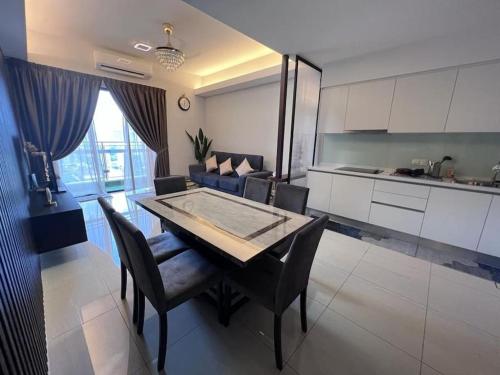 a kitchen and dining room with a table and chairs at Sentral Suites Kuala lumpur By Leyla 3BR suites 8 pax in Kuala Lumpur