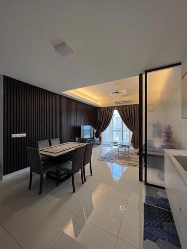 a kitchen and dining room with a table and chairs at Sentral Suites Kuala lumpur By Leyla 3BR suites 8 pax in Kuala Lumpur