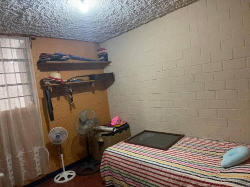 a bedroom with a bed and a ceiling at comfortable and spacious house with garage in Amatitlán