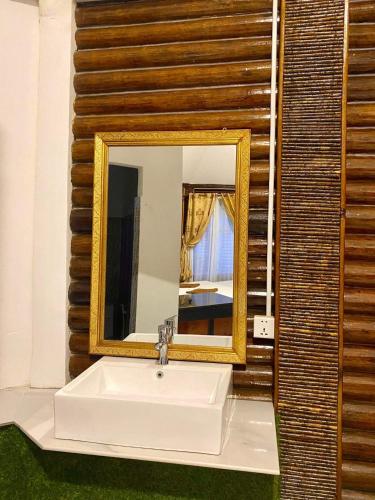 a bathroom with a white sink and a mirror at M'pay Bay Guesthouse in Koh Rong Sanloem
