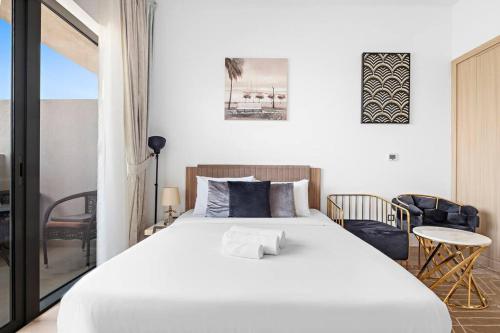 1 dormitorio con 1 cama blanca grande en una habitación en Perfect Getaway Studio APT Aura by Aziza, en Dubái