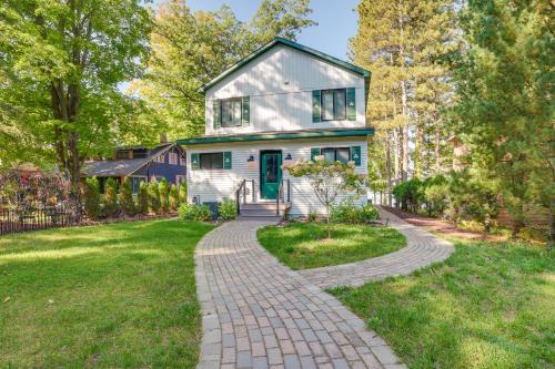 a house with a brick walkway in front of it at Higgins Lake Vacation Rental with Lake Views and Deck! in Roscommon