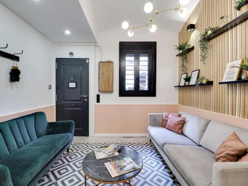 a living room with a couch and a table at Casa Maria Townhouse- terrace-4 bedrooms in Hospitalet de Llobregat