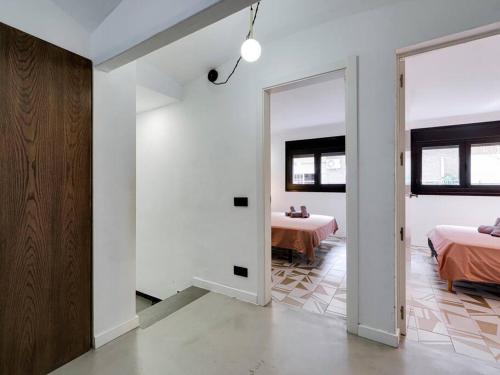 a bedroom with two beds and a mirror at Casa Maria Townhouse- terrace-4 bedrooms in Hospitalet de Llobregat