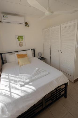 a bedroom with a large bed with white sheets at Mahale - Quepos Manuel Antonio Reserve in Quepos