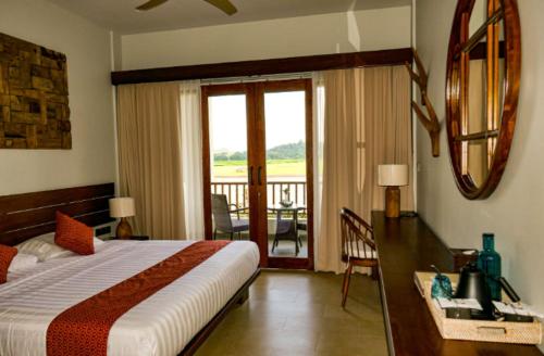 a hotel room with a bed and a balcony at Santai Toraja in Rantepao