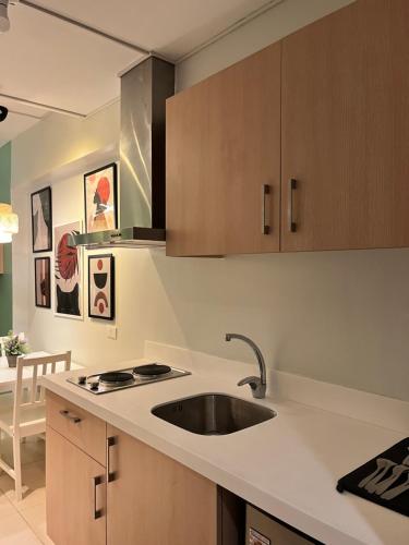 a kitchen with a sink and a counter top at Relaxing and Cozy Unit at The Residences in Manila