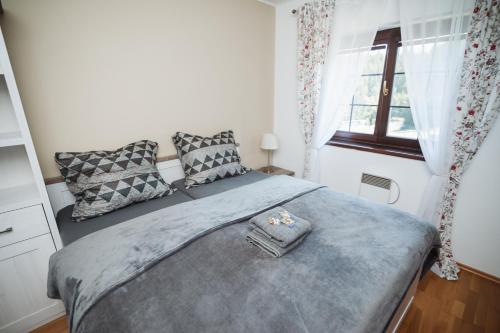 a bedroom with a bed and a window at Vila Viktória - Apartmán Viktória 2 in Ružomberok