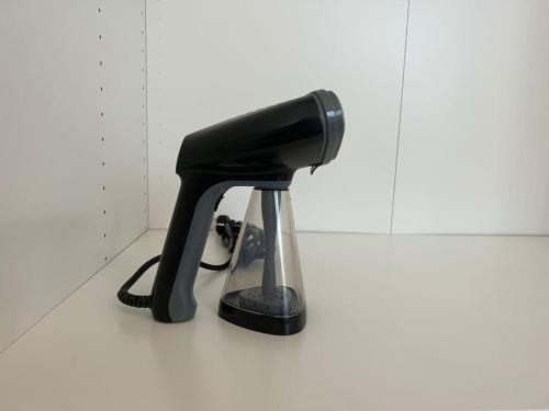 a black hair dryer sitting on top of a counter at Harmonieux/Bezannes/Pkg Privé in Bezannes-les-Reims