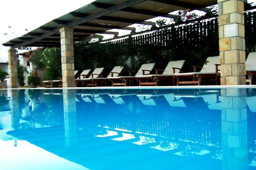 a swimming pool with lounge chairs and a swimming pool at Vina Beach Hotel in Skiros