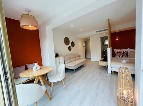 un salon avec une table et une chambre dans l'établissement Riviera, à Cagnes-sur-Mer