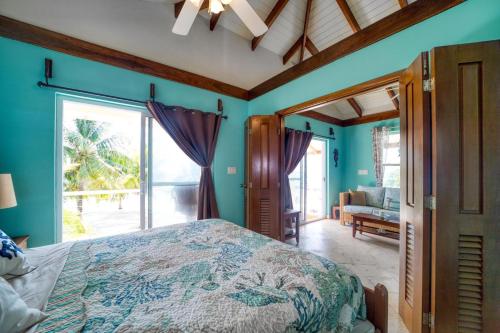 a bedroom with a bed and a large window at Lucky Duck Villa - Private Beach Escape in Maya Beach