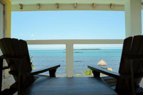a view of the ocean from the porch of a house at Lucky Duck Villa - Private Beach Escape in Maya Beach