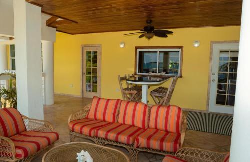 a living room with two couches and a table at Lucky Duck Villa - Private Beach Escape in Maya Beach