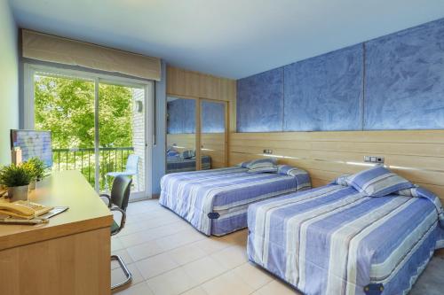 Postel nebo postele na pokoji v ubytování Hotel Sausa
