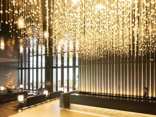 a lobby with a large chandelier in a building at Mitsui Garden Hotel Nihonbashi Premier in Tokyo