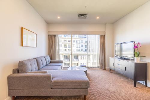 a living room with a couch and a tv at Seasons Botanic Gardens in Melbourne