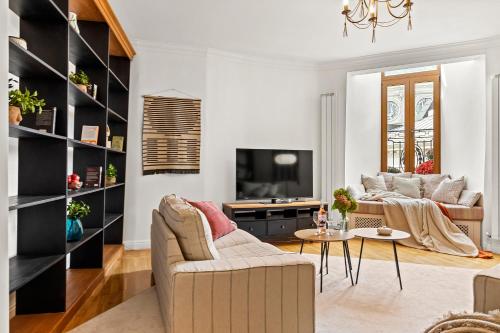 a living room with a couch and a table at 2 Bedroom Apartment - Romanian Athenaeum in Bucharest