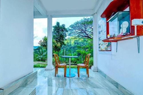 a room with a table and two chairs and a window at Ella Eco Adventure Point in Bandarawela