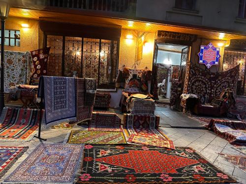 a store with lots of carpets on display in a room at Terrace Tbilisi Center in Tbilisi City