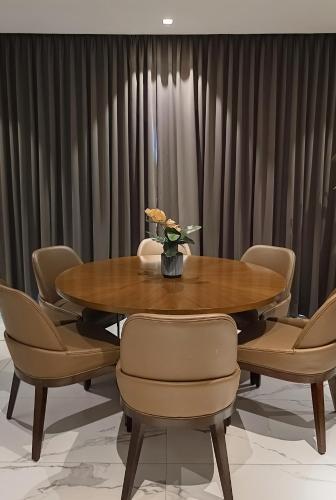 a dining room with a wooden table and chairs at The Henry Hotel Roost Bacolod in Bacolod
