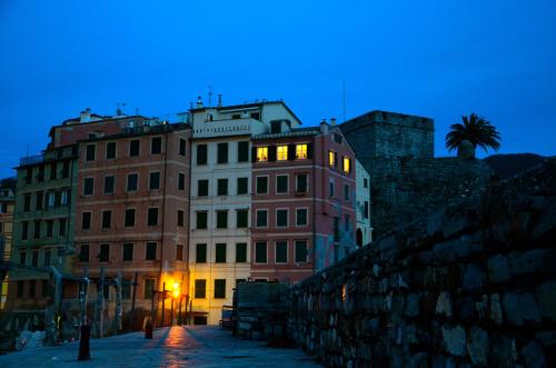 a group of buildings on a street at night at I Tre Merli Locanda in Camogli