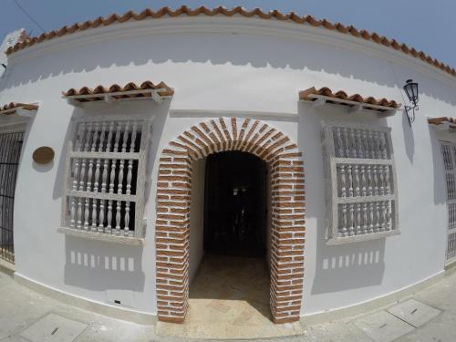 an entrance to a building with an arch and windows at Hotel La Magdalena in Cartagena de Indias