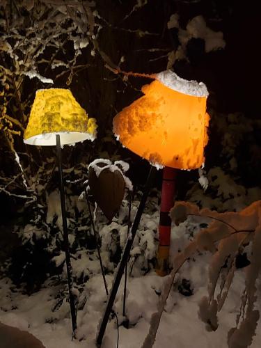 two street lights in the snow at night at Hotel Bergbauer mit Late-Self-Check-IN in Neuburg an der Donau