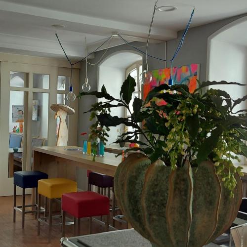 a kitchen with a large vase with a plant in it at Hotel Bergbauer mit Late-Self-Check-IN in Neuburg an der Donau