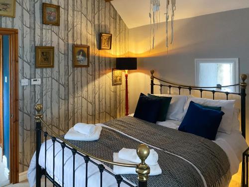 a bedroom with a bed with towels on it at The Stables in Waltham on the Wolds