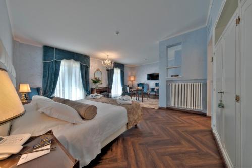 a hotel room with a large bed and a desk at Hotel President Terme in Abano Terme