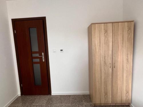 a room with a door and a wooden cabinet at Noclegi - Pokoje - STEMPO in Skarżysko-Kamienna