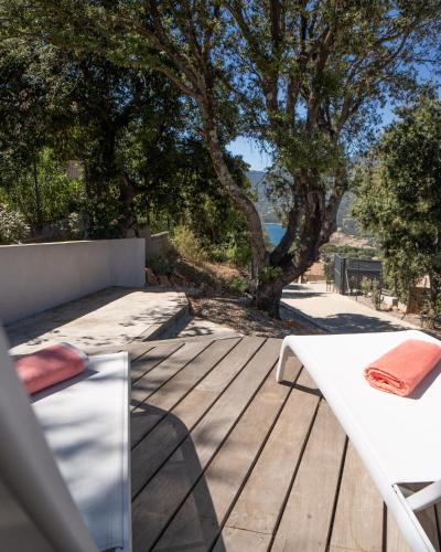 a white table and chairs on a wooden deck at Villa Cupabia vue mer in Viggianello