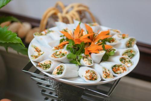 a plate of deviled eggs on a plate with carrots at Gloud Hotel in Hanoi
