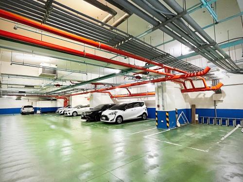 a parking garage with several cars parked in it at Vasty Jiaoxi Hotel in Jiaoxi