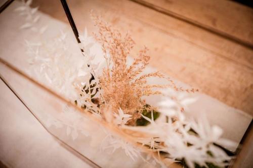 a dried plant sitting on top of a wooden table at The Wine Loft in Quorndon