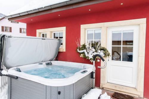 a hot tub outside of a house in the snow at Doller Villa 4 stars Hot Tub Mountain Ski Ballon d'Alsace in Sewen