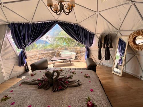 a person laying on a bed in a yurt at Phuket Signature Glamping in Rawai Beach