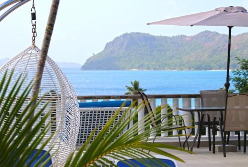 a view of the ocean from the balcony of a resort at Ocean Blue Bay in Anse Volbert Village