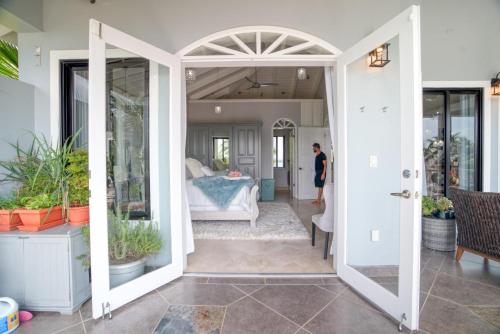 a room with a door open to a bedroom at Kairos Villa - Luxury Ocean Front - 4 Bedrooms with 2 Private Pools & Beach in Maya Beach