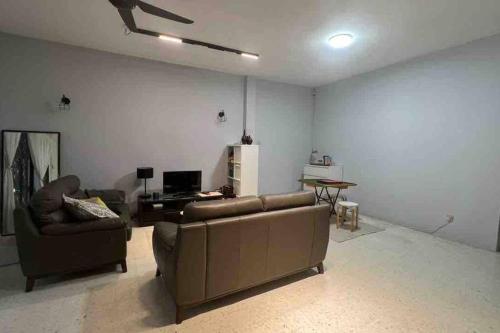 a living room with two couches and a table at 311 Nana’s Homes BBQ, Games, Netflix 11pax in Ampang