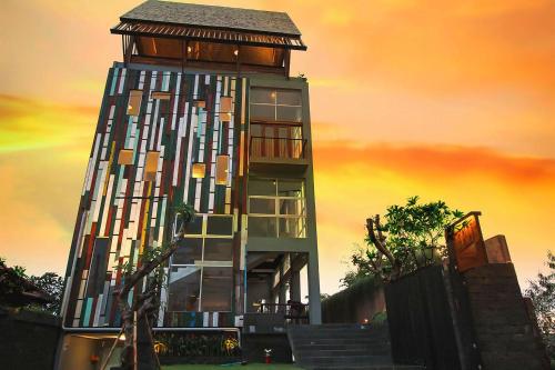 a tall building with a roof on top of it at FRii Bali Echo Beach in Canggu