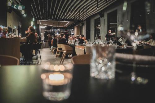 a restaurant with people sitting at tables and chairs at Aves Arosa in Arosa