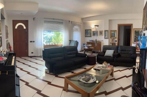 a living room with couches and a coffee table at Villa Le Anfore in Imperia